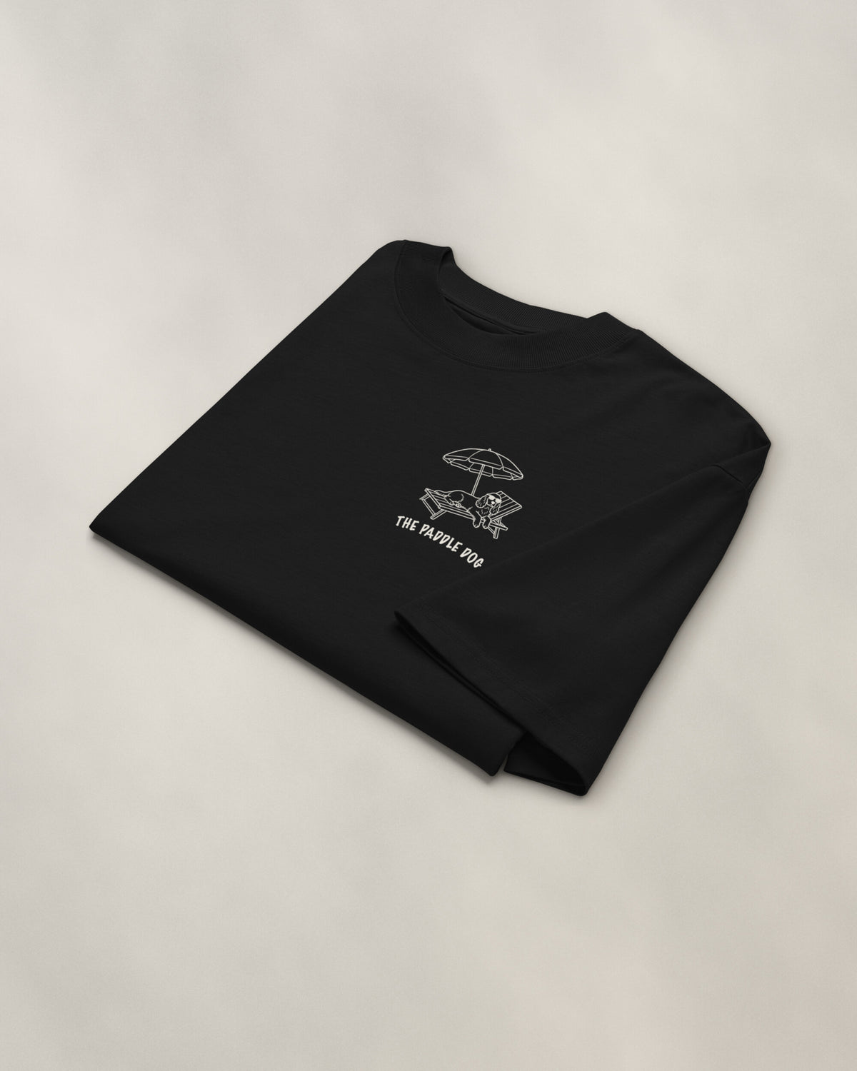 Marbella Chapter Tee - Black, folded, the crest on the chest