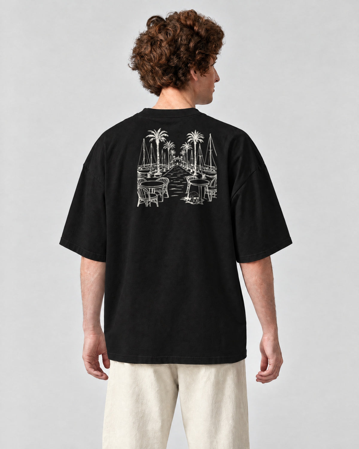 Marbella Chapter Tee - Black on a model, from behind