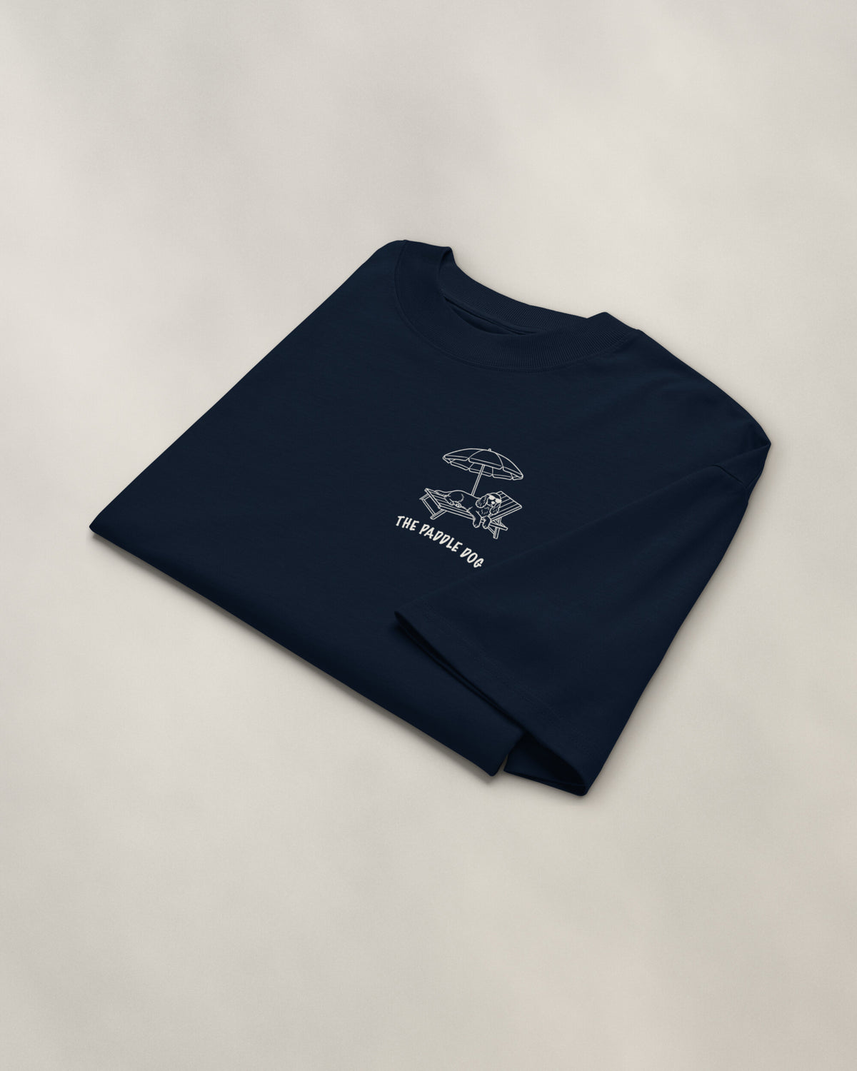 Marbella Chapter Tee - Navy, folded, the crest on the chest