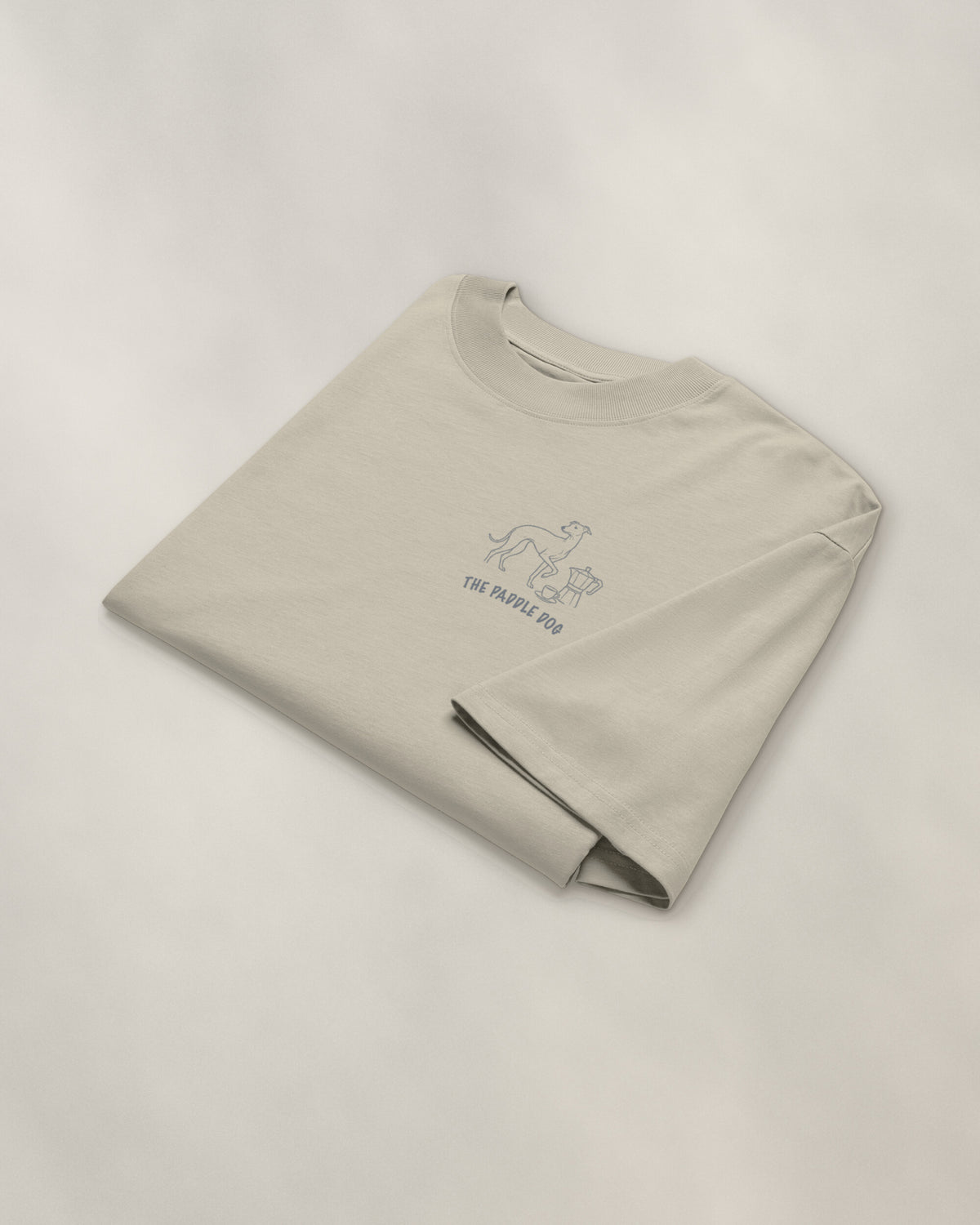 Milano Chapter Tee - Stone, folded, the crest on the chest